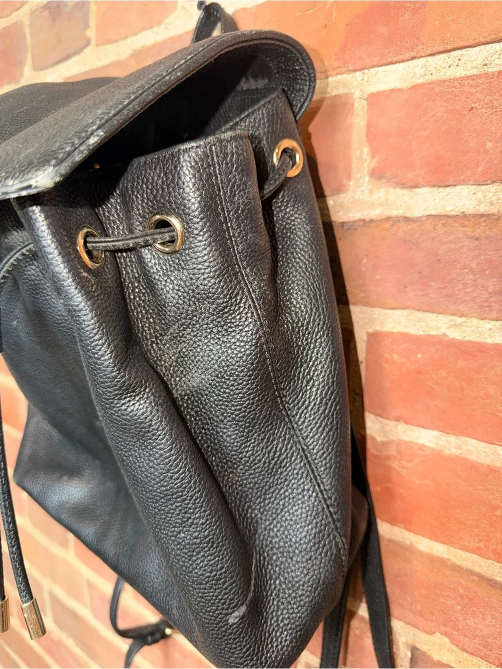 kate spade black pebbled leather flap drawstring backpack